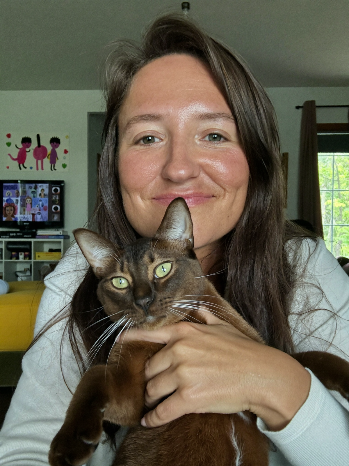 Lifestyle image of a cat and owner at home