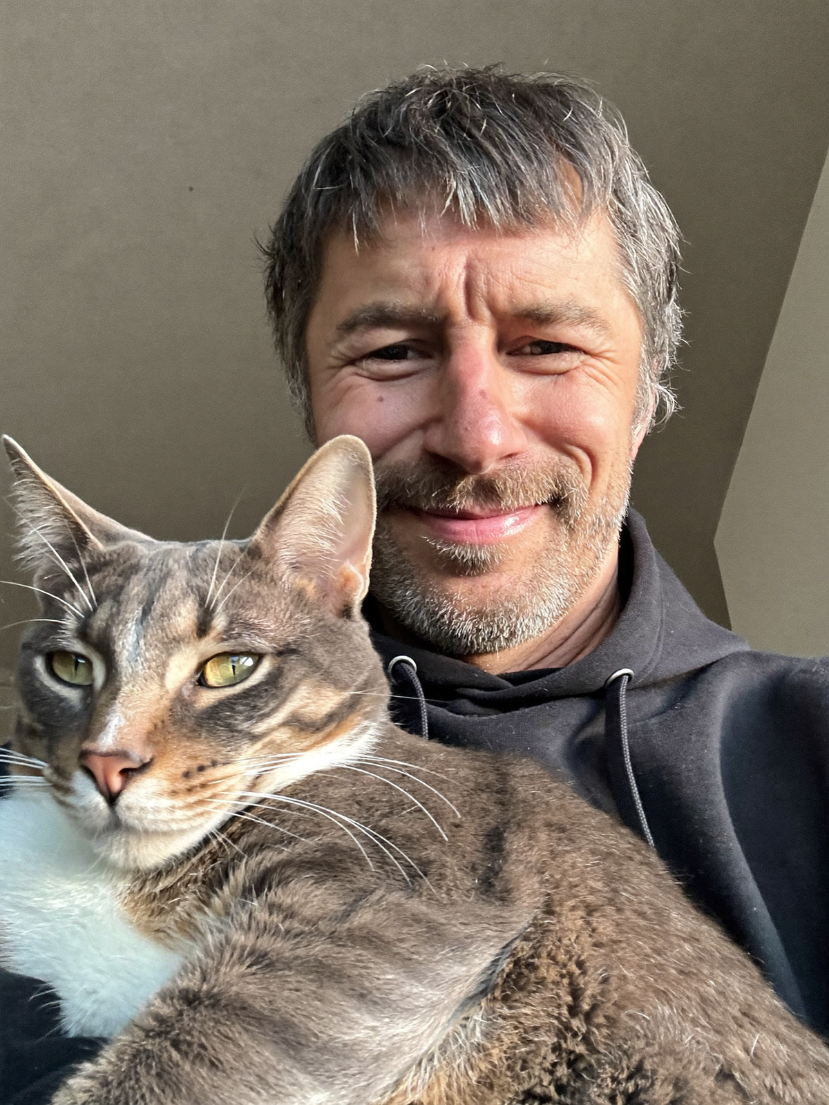 Lifestyle image of a cat and owner at home